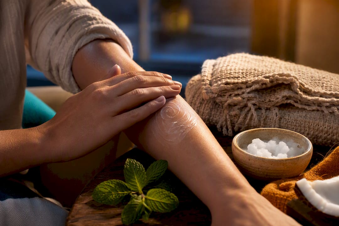 Hands applying lotion to a forearm