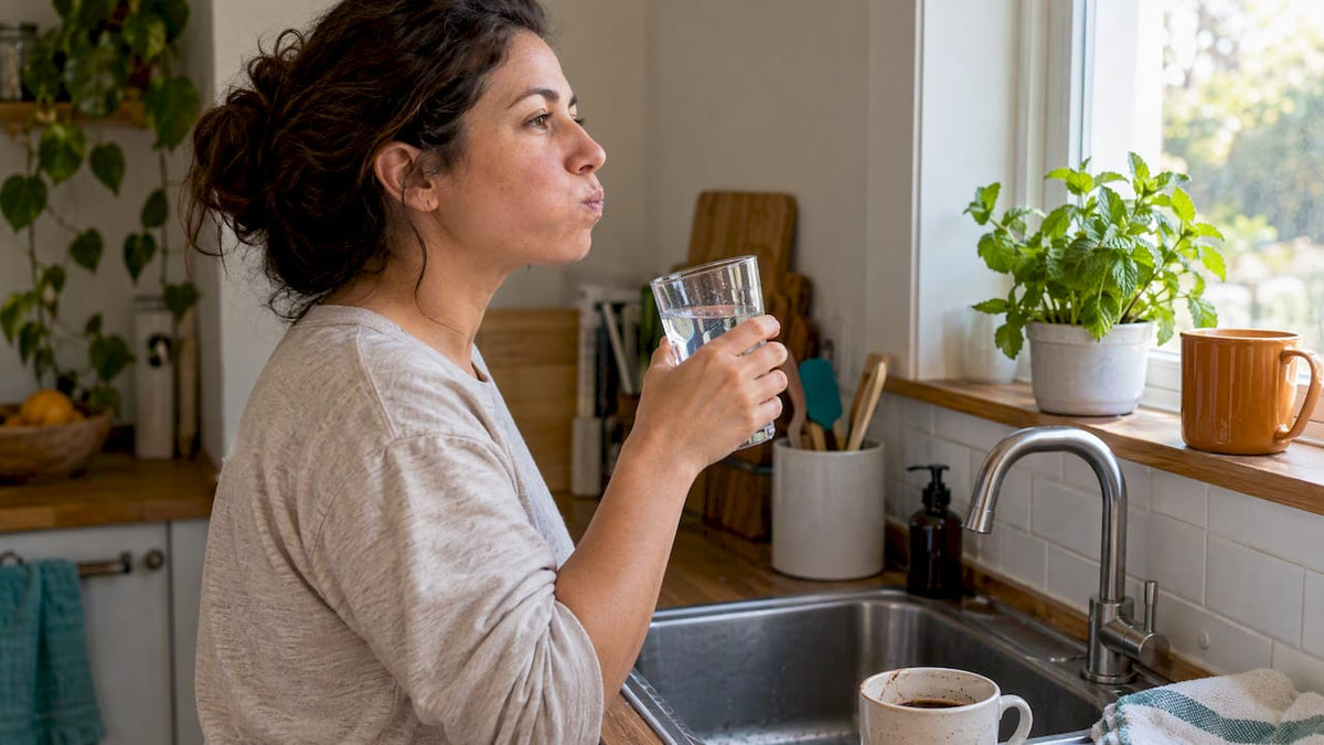Woman swishing water after drinking coffee